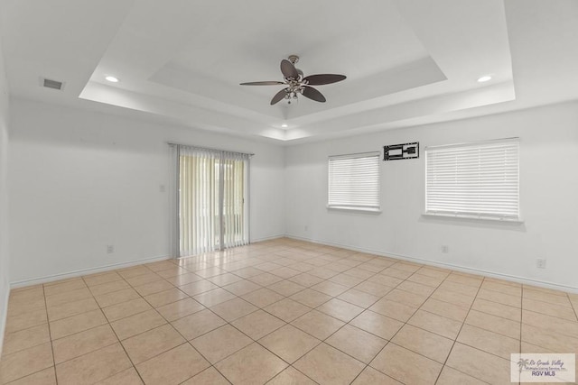 1000 E Palm Valley Dr, Palm Valley, TX 78552 - unfurnished room with a tray ceiling, ceiling fan, recessed lighting, and light tile patterned flooring