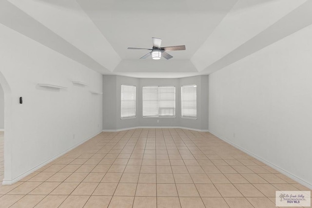 1000 E Palm Valley Dr, Palm Valley, TX 78552 - spare room with ceiling fan, a raised ceiling, arched walkways, and light tile patterned flooring
