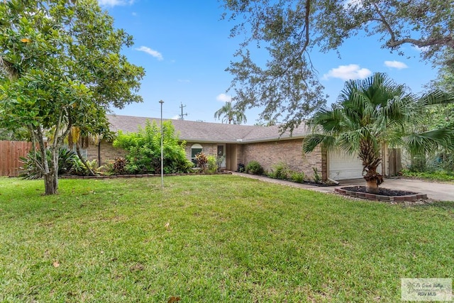 1000 E Palm Valley Dr, Palm Valley, TX 78552 - view of front facade featuring an attached garage, concrete driveway, and brick siding