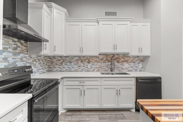 1000 E Palm Valley Dr, Palm Valley, TX 78552 - kitchen featuring black electric range oven, wall chimney range hood, dishwashing machine, and light countertops