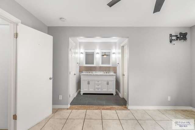 1000 E Palm Valley Dr, Palm Valley, TX 78552 - bathroom with double vanity, tile patterned floors, ceiling fan, and tasteful backsplash