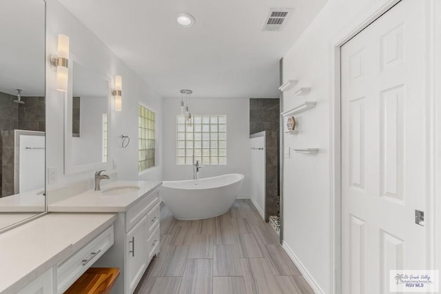 1000 E Palm Valley Dr, Palm Valley, TX 78552 - full bathroom with a walk in shower, vanity, a freestanding bath, and recessed lighting