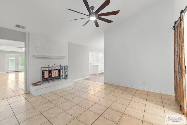 1000 E Palm Valley Dr, Palm Valley, TX 78552 - unfurnished living room featuring ceiling fan, light tile patterned floors, a barn door, and high vaulted ceiling