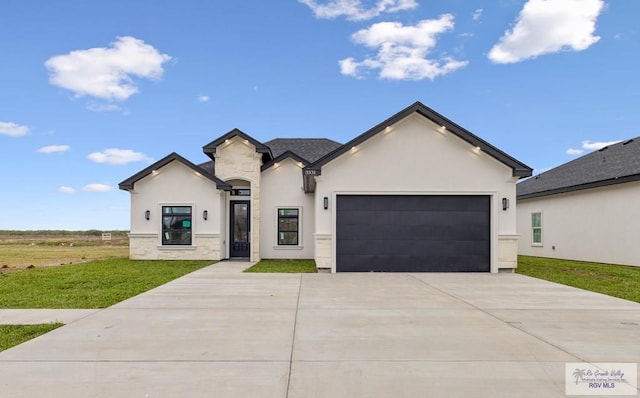 view of front of house featuring a garage and a front lawn