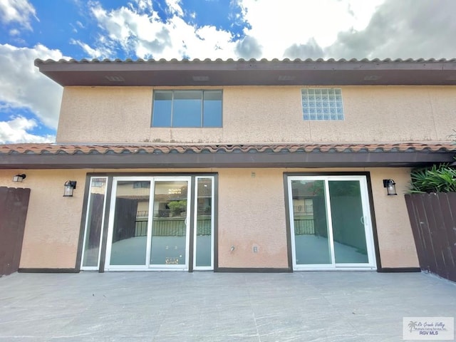 rear view of property featuring a patio area