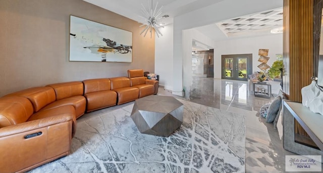 living room with french doors and a chandelier