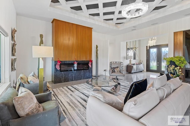 tiled living room featuring ceiling fan, beam ceiling, french doors, and coffered ceiling