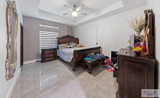 bedroom featuring a tray ceiling and ceiling fan