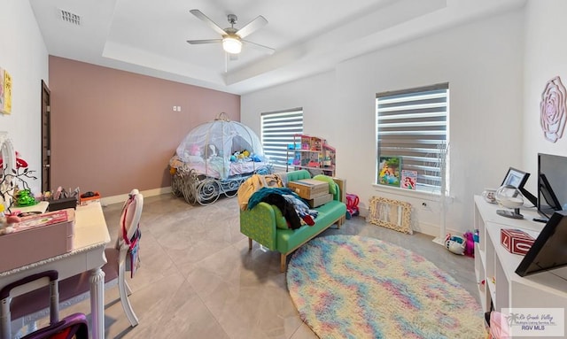 bedroom featuring a tray ceiling and ceiling fan