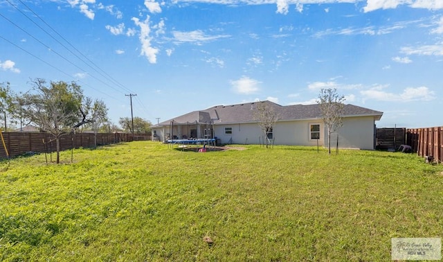 exterior space featuring a yard and a trampoline