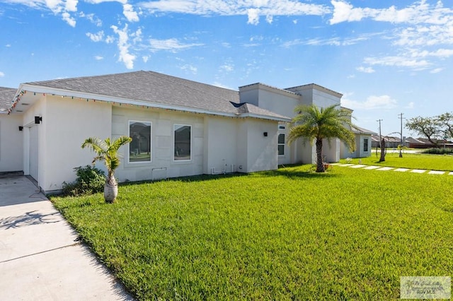 view of side of home featuring a yard and a garage