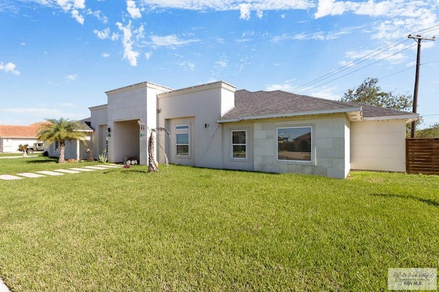 rear view of property featuring a yard