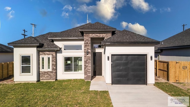 view of front of house with fence, a front yard, stucco siding, driveway, and an attached garage