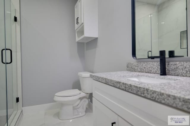 bathroom with vanity, baseboards, a shower stall, toilet, and marble finish floor