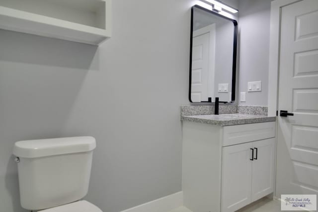 bathroom featuring toilet and vanity