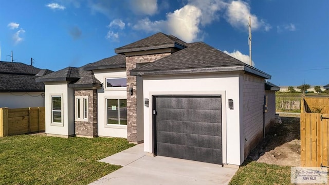 view of front of home featuring a garage, a front yard, driveway, and fence