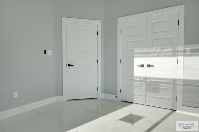 entryway featuring baseboards and marble finish floor