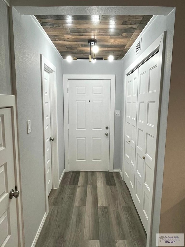 doorway with wooden ceiling and dark hardwood / wood-style flooring