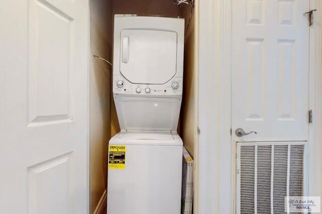 laundry area featuring stacked washer and clothes dryer