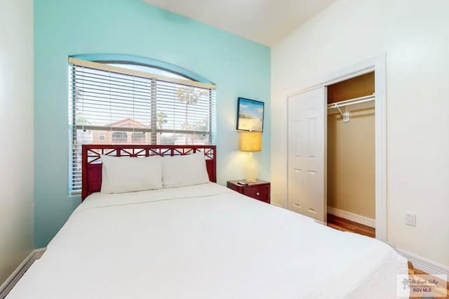 bedroom featuring hardwood / wood-style flooring and a closet