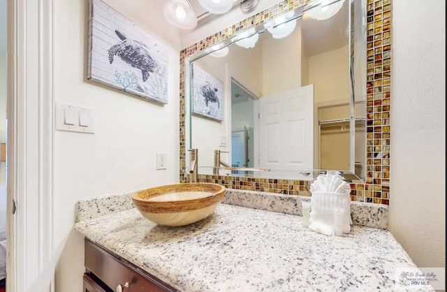 bathroom with decorative backsplash and vanity