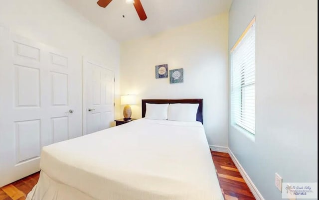 bedroom featuring hardwood / wood-style floors, a closet, and ceiling fan