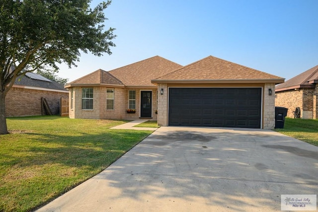 ranch-style home with a garage and a front lawn