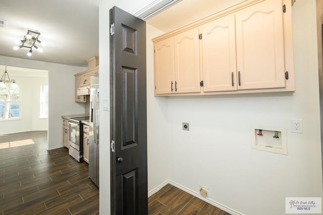 interior space with washer hookup, dark hardwood / wood-style flooring, cabinets, and hookup for an electric dryer