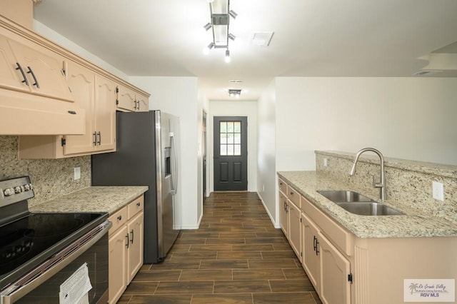 kitchen featuring light stone counters, dark hardwood / wood-style flooring, stainless steel appliances, and sink