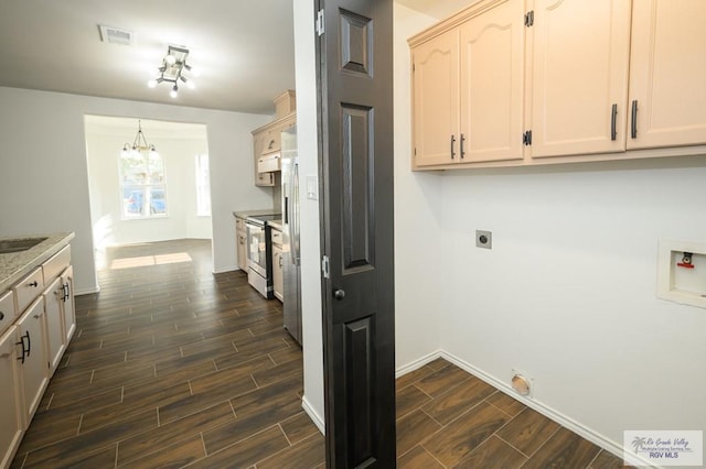 laundry area featuring cabinets, hookup for a washing machine, dark hardwood / wood-style flooring, and electric dryer hookup