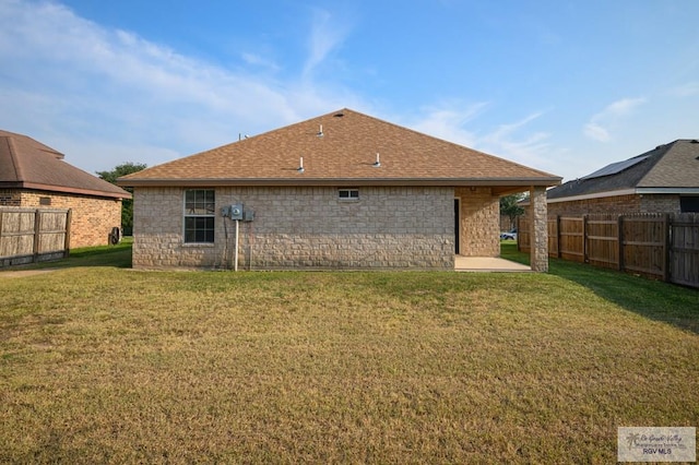 back of property featuring a lawn