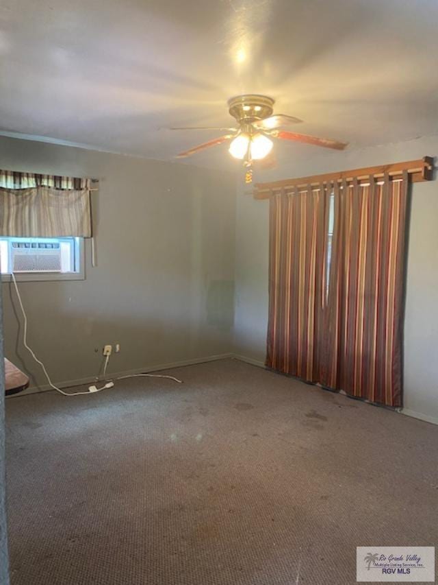 carpeted empty room featuring ceiling fan and cooling unit