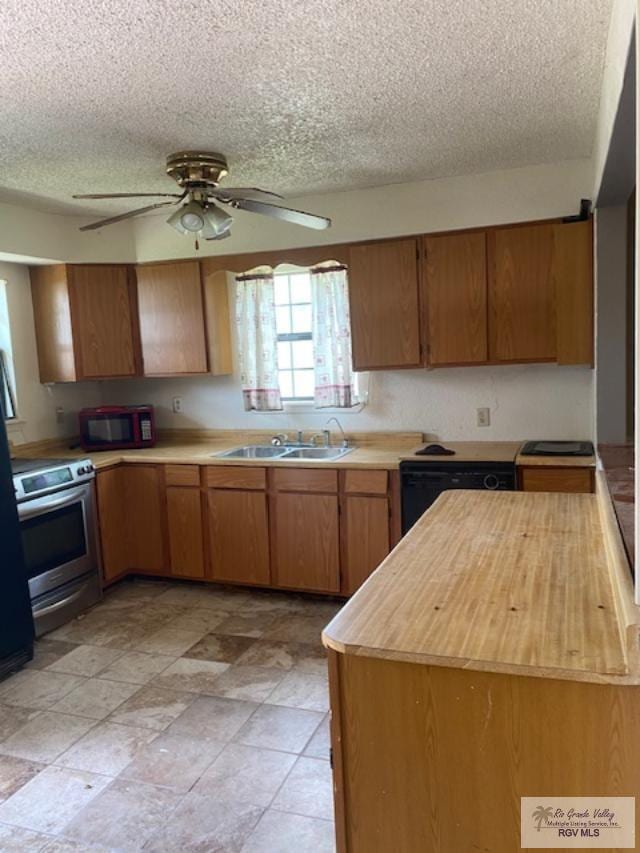 kitchen featuring ceiling fan, a textured ceiling, stainless steel range with electric stovetop, and sink