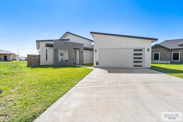 1749 Vincent St, Donna, TX 78537 - contemporary home featuring an attached garage, driveway, a front yard, and stucco siding