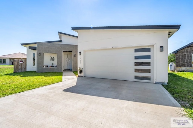 1749 Vincent St, Donna, TX 78537 - contemporary house featuring a garage, concrete driveway, a front lawn, and stucco siding