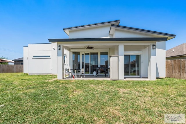 1749 Vincent St, Donna, TX 78537 - rear view of house featuring a lawn, fence, a patio, and ceiling fan