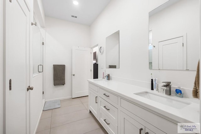 1749 Vincent St, Donna, TX 78537 - bathroom featuring tile patterned floors, double vanity, visible vents, a sink, and a stall shower