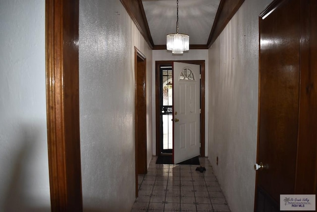 doorway featuring a notable chandelier and ornamental molding