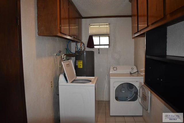 laundry room with washer and clothes dryer, water heater, cabinets, a textured ceiling, and light tile patterned flooring