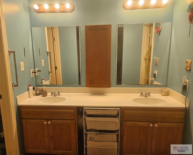 bathroom featuring double vanity and a sink