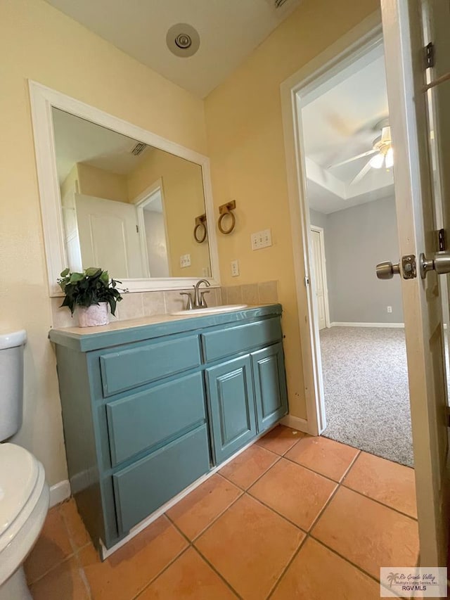 bathroom featuring ceiling fan, tile patterned flooring, vanity, and toilet