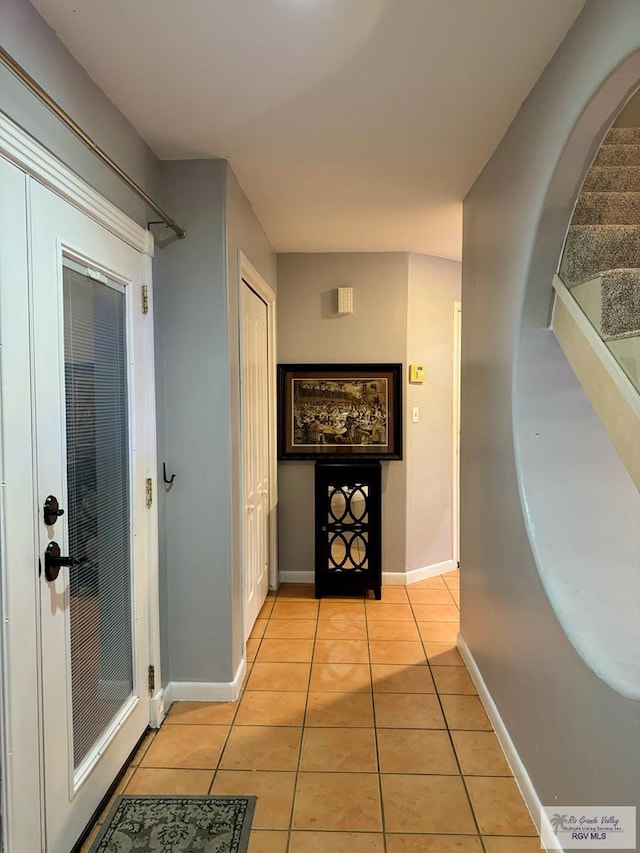 hall featuring light tile patterned flooring