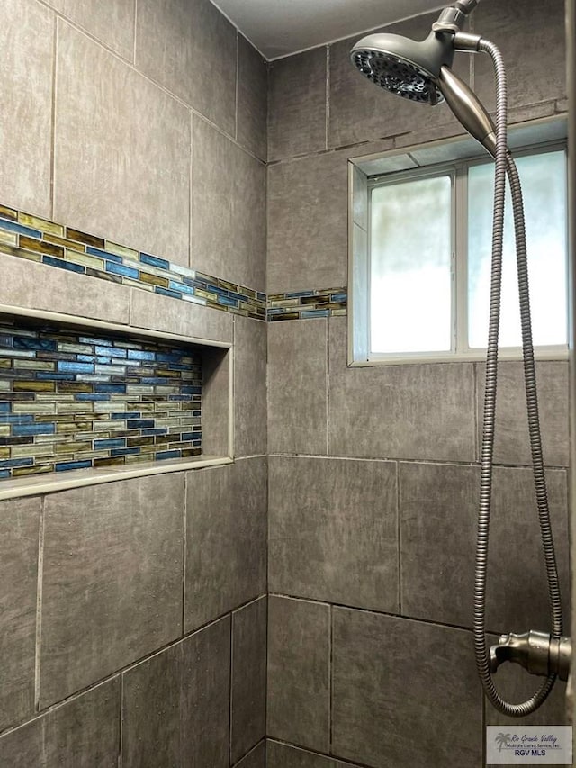 bathroom with tiled shower