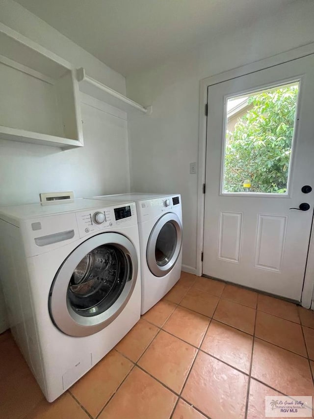 laundry room featuring light tile patterned floors and washer and dryer