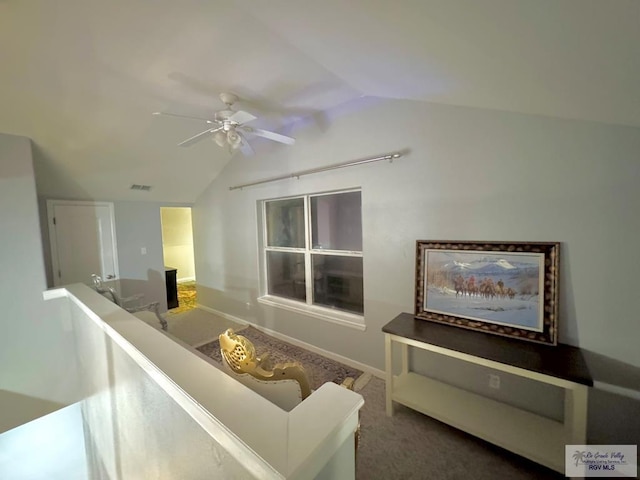 living room with carpet flooring, ceiling fan, and lofted ceiling