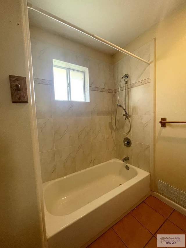 bathroom with tiled shower / bath combo and tile patterned floors