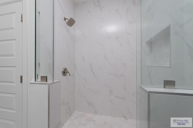 bathroom with a tile shower