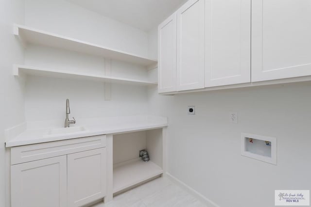 8879 Wentz Lk, Brownsville, TX 78520 - laundry area featuring hookup for an electric dryer, washer hookup, cabinet space, and light tile patterned flooring