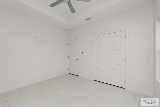 unfurnished bedroom with ceiling fan and a closet