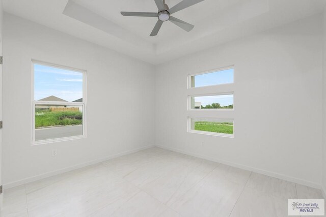 empty room with light tile patterned floors and ceiling fan